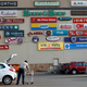 A shopper loads groceries into his car as logos of shops are seen on a wall at a shopping centre in Lenasia, south of Johannesburg.